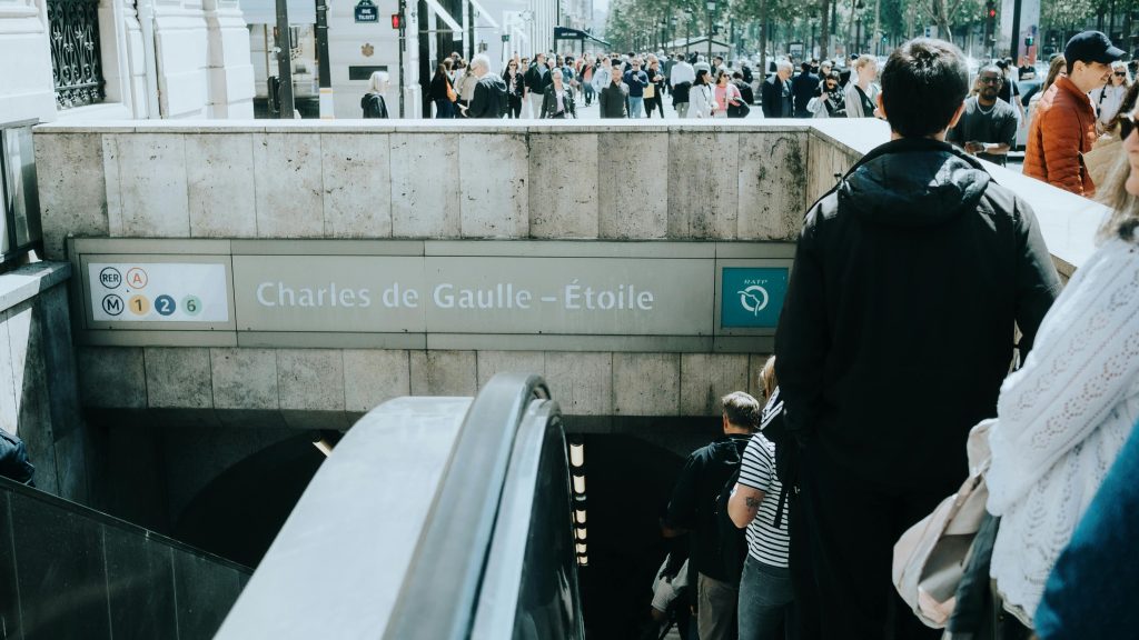 Crowds entering and exiting the Charles de Gaulle–Étoile metro station in Paris, France.